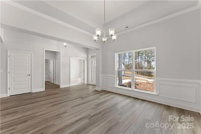 1469 Mocksville Hwy Unit 21, Statesville, NC 28625 - unfurnished dining area with a chandelier, wood finished floors, crown molding, and wainscoting