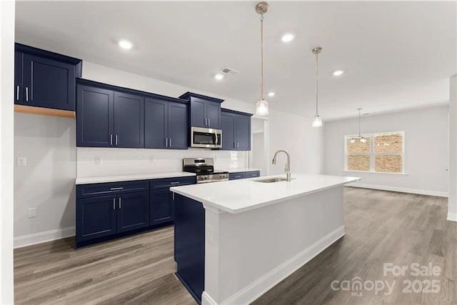1469 Mocksville Hwy Unit 21, Statesville, NC 28625 - kitchen with a sink, stainless steel appliances, baseboards, light wood-style floors, and a center island with sink