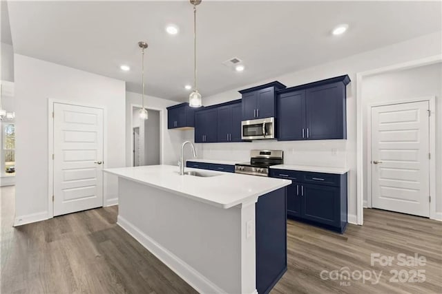 1469 Mocksville Hwy Unit 21, Statesville, NC 28625 - kitchen with stainless steel appliances, a sink, wood finished floors, light countertops, and recessed lighting