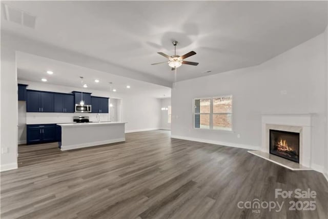 1469 Mocksville Hwy Unit 21, Statesville, NC 28625 - unfurnished living room with dark wood-style flooring, a premium fireplace, a ceiling fan, recessed lighting, and a sink