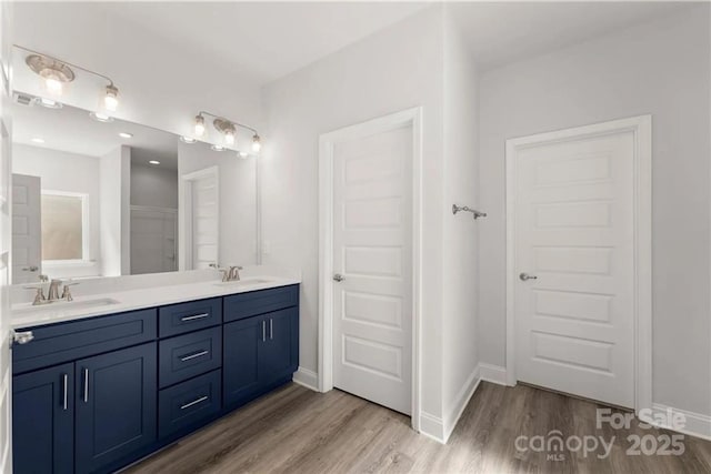 1469 Mocksville Hwy Unit 21, Statesville, NC 28625 - full bathroom featuring wood finished floors, double vanity, and baseboards