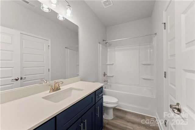 1469 Mocksville Hwy Unit 21, Statesville, NC 28625 - bathroom featuring wood finished floors, toilet, vanity, and shower / washtub combination