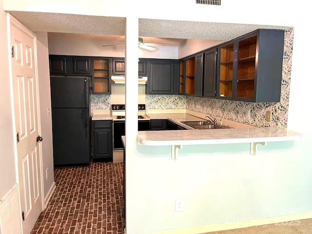 5810 Harris Grove Ln, Charlotte, NC 28212 - kitchen with ceiling fan, white range with electric stovetop, a sink, freestanding refrigerator, and a breakfast bar area
