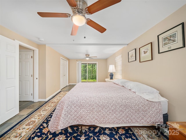 19 Old Patton Hill Rd, Swannanoa, NC 28778 - bedroom with ceiling fan, stone finish floors, and baseboards