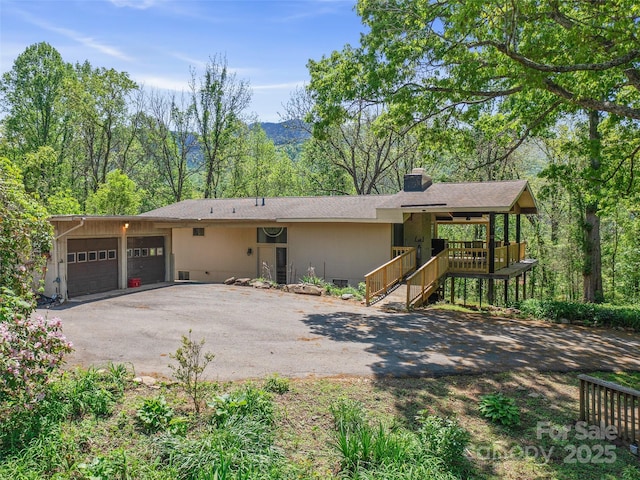 19 Old Patton Hill Rd, Swannanoa, NC 28778 - view of front of home with asphalt driveway, a garage, and a chimney