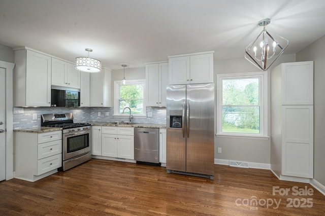 692 S Pink St, Cherryville, NC 28021 - kitchen featuring decorative backsplash, white cabinetry, stainless steel appliances, and a sink