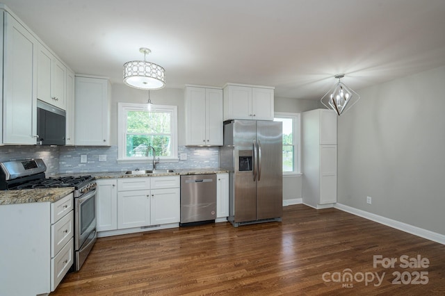 692 S Pink St, Cherryville, NC 28021 - kitchen with dark wood-style floors, stainless steel appliances, a sink, baseboards, and tasteful backsplash