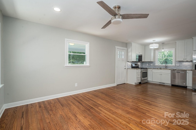 692 S Pink St, Cherryville, NC 28021 - kitchen with stainless steel appliances, baseboards, decorative backsplash, and dark wood-style flooring
