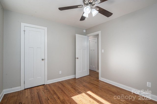 692 S Pink St, Cherryville, NC 28021 - unfurnished bedroom with baseboards, a ceiling fan, and wood finished floors