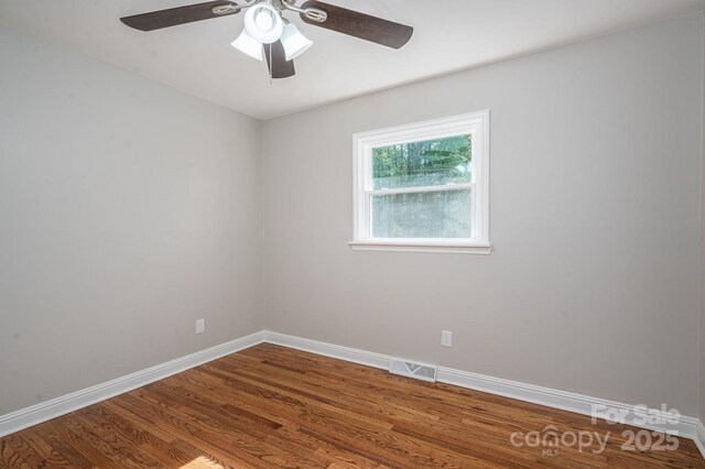 692 S Pink St, Cherryville, NC 28021 - spare room with visible vents, wood finished floors, baseboards, and a ceiling fan