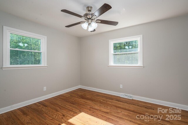 692 S Pink St, Cherryville, NC 28021 - spare room with baseboards, a healthy amount of sunlight, wood finished floors, and visible vents