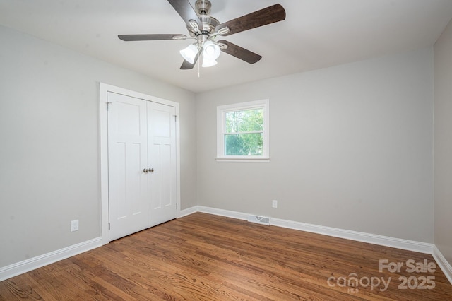 692 S Pink St, Cherryville, NC 28021 - unfurnished bedroom with a closet, wood finished floors, visible vents, and baseboards
