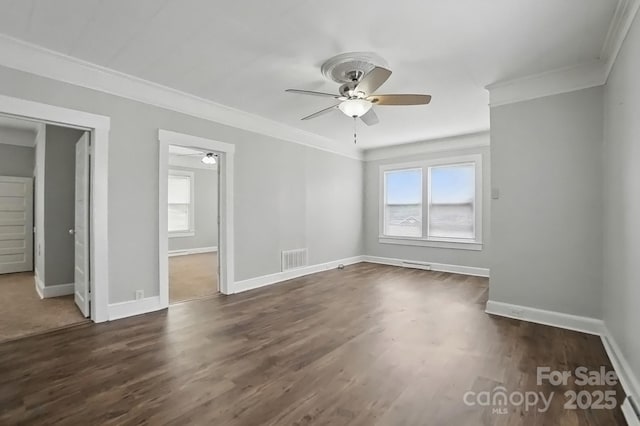 unfurnished bedroom with visible vents, ornamental molding, dark wood-style floors, and baseboards