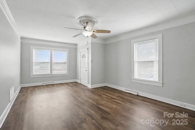 empty room with crown molding, a ceiling fan, dark wood-type flooring, and visible vents