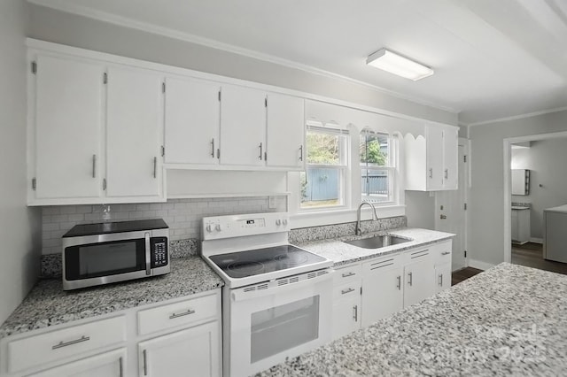 kitchen featuring white range with electric cooktop, stainless steel microwave, white cabinetry, and a sink