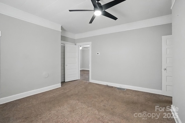 unfurnished bedroom featuring ceiling fan, baseboards, carpet flooring, and visible vents