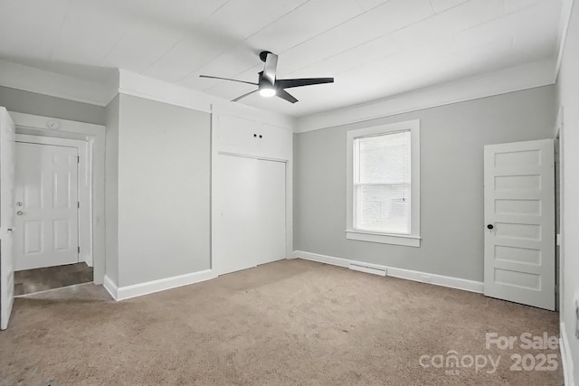 unfurnished bedroom with a ceiling fan, a closet, carpet floors, baseboards, and visible vents