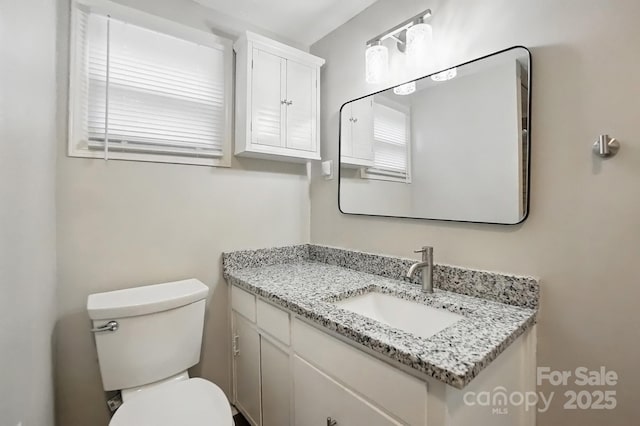 half bath featuring toilet and vanity