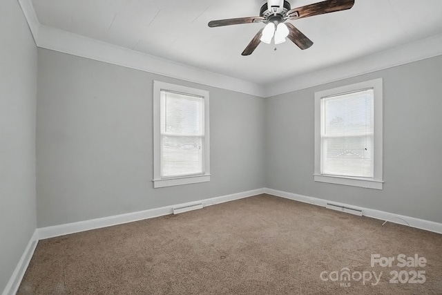 carpeted empty room with baseboards, visible vents, and a healthy amount of sunlight