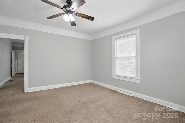 spare room with visible vents, carpet flooring, baseboards, and ceiling fan