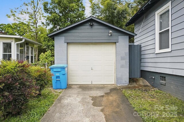 detached garage featuring driveway