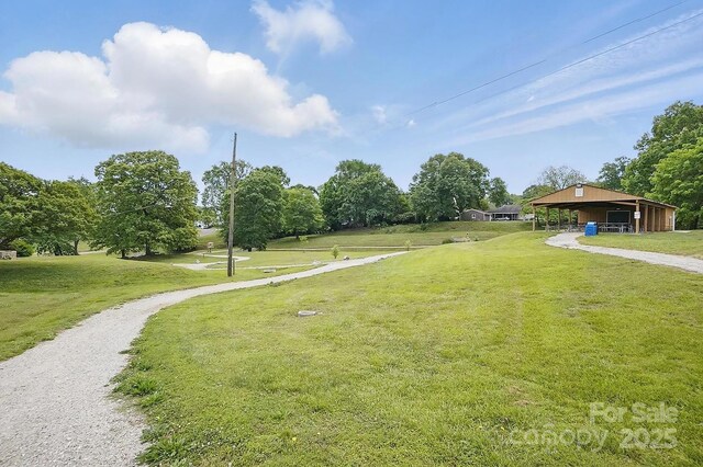 view of community with a lawn and driveway