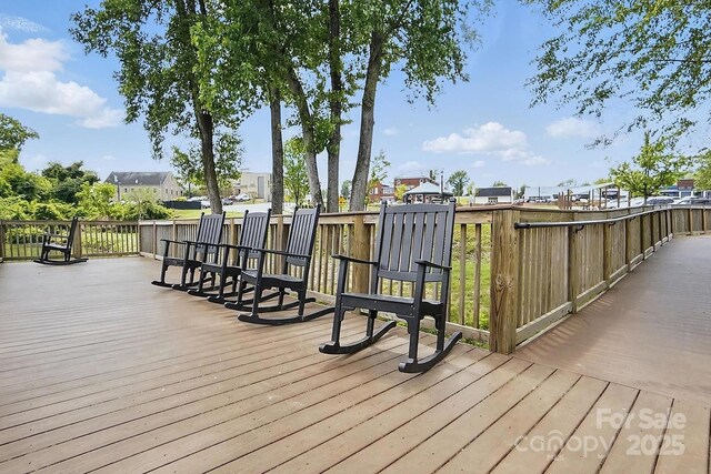 wooden deck featuring a residential view
