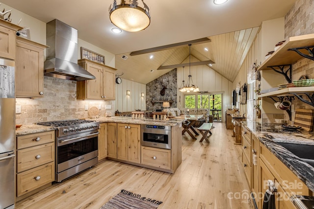 kitchen featuring a peninsula, light brown cabinetry, wall chimney range hood, light wood finished floors, and appliances with stainless steel finishes