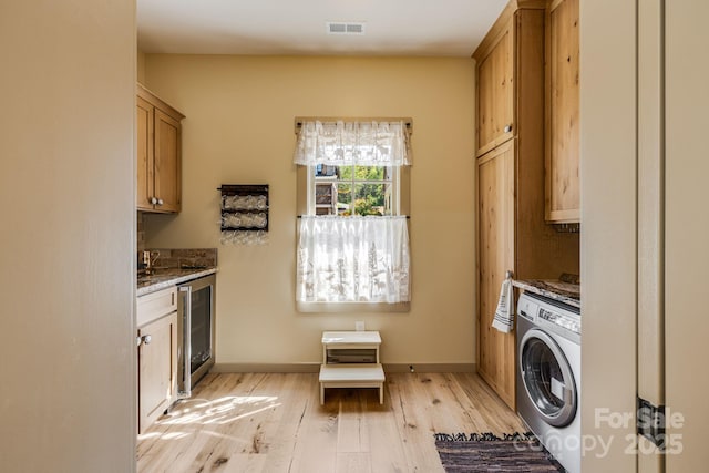 laundry room with washer / clothes dryer, visible vents, cabinet space, wine cooler, and light wood-style flooring
