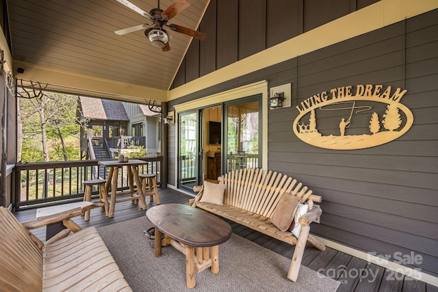 wooden terrace with a ceiling fan and covered porch