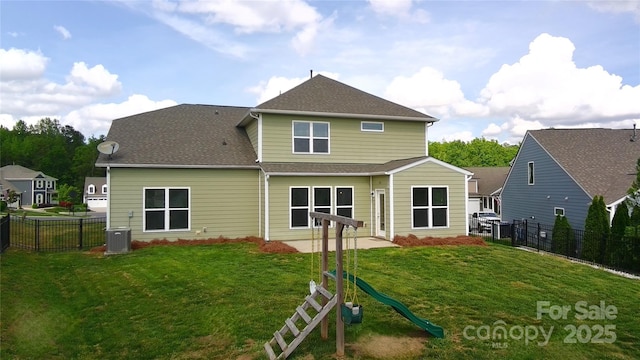 15747 Reynolds Dr, Indian Land, SC 29707 - rear view of house with a lawn, a fenced backyard, roof with shingles, and central AC