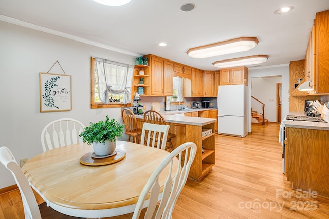 dining space featuring crown molding, recessed lighting, stairs, and light wood-style flooring