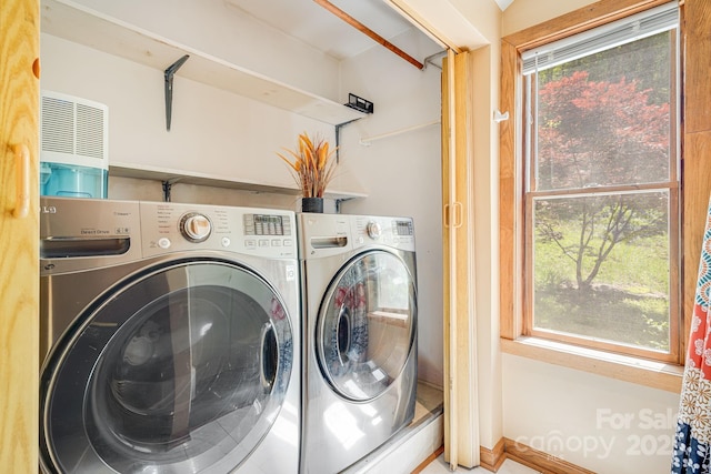 laundry area featuring laundry area, baseboards, and washer and dryer
