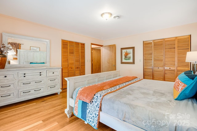 bedroom with crown molding and light wood-style flooring
