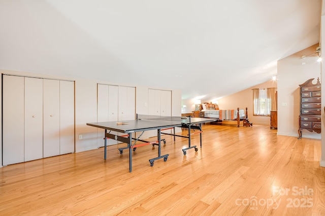 game room with light wood-type flooring and lofted ceiling