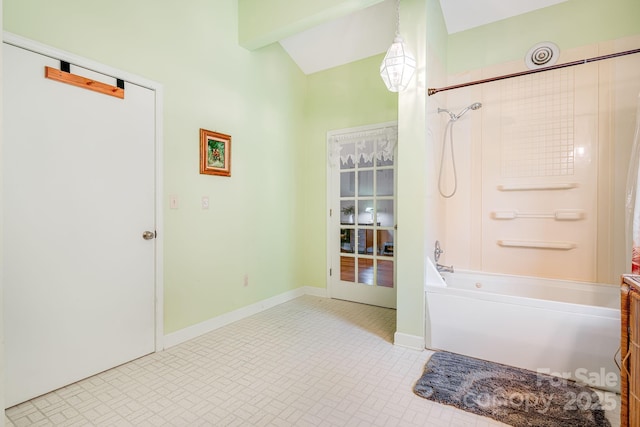 bathroom featuring vaulted ceiling with beams, baseboards, shower / bathtub combination, and brick patterned floor