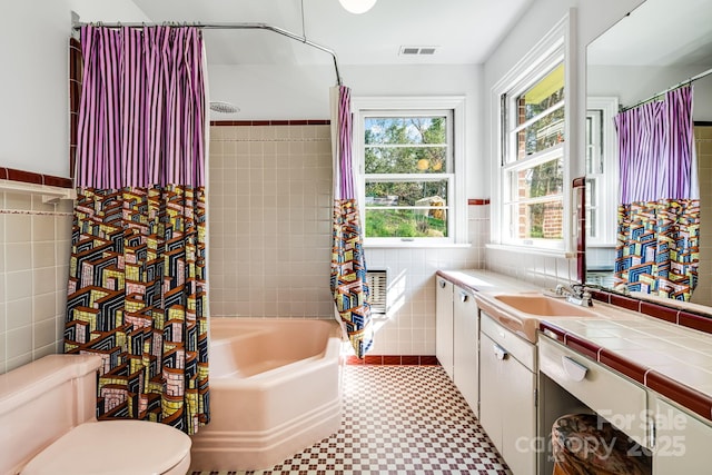 80 Sunset Dr, Marshall, NC 28753 - full bath with tile walls, toilet, vanity, visible vents, and shower / bath combination with curtain
