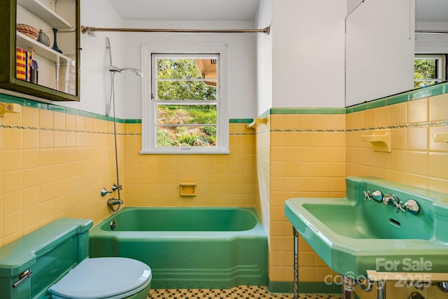 80 Sunset Dr, Marshall, NC 28753 - full bath featuring toilet, tile walls, wainscoting, and a wealth of natural light