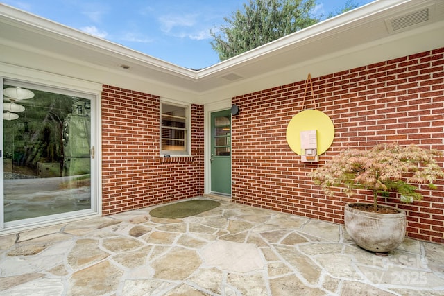 80 Sunset Dr, Marshall, NC 28753 - doorway to property featuring a patio area, brick siding, and visible vents