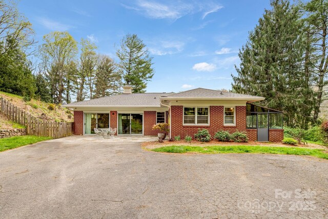 80 Sunset Dr, Marshall, NC 28753 - single story home with a chimney, brick siding, aphalt driveway, and fence