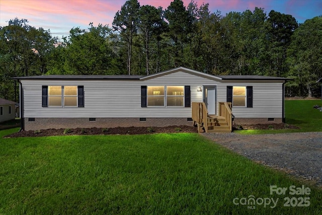manufactured / mobile home with a lawn and crawl space