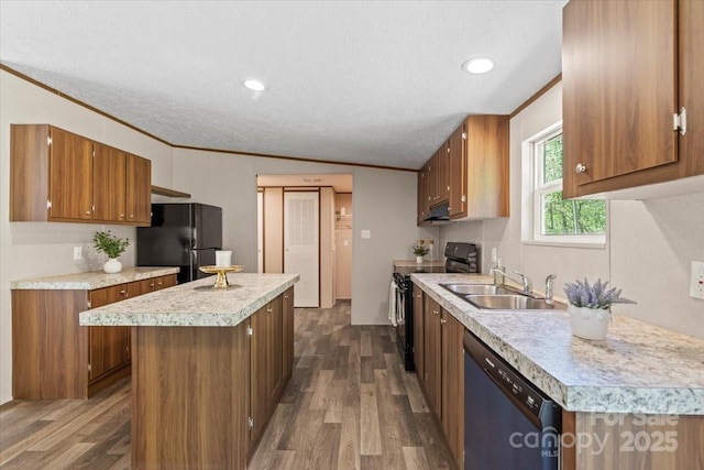 kitchen with a center island, a sink, dark wood-style flooring, light countertops, and black appliances