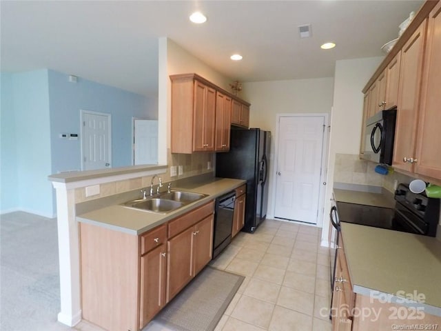 kitchen with recessed lighting, a sink, backsplash, and black appliances