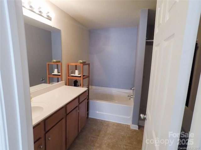 full bathroom featuring a bath and vanity