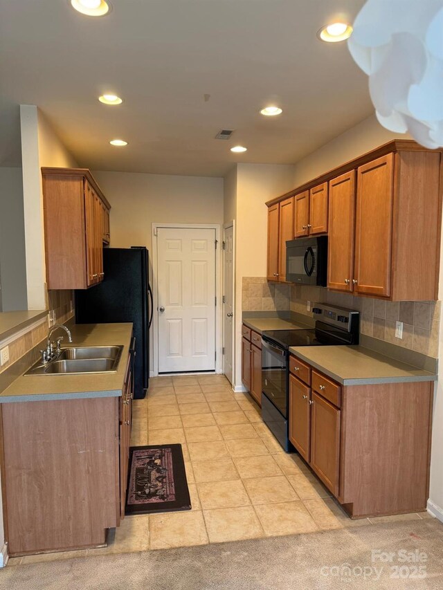 9668 Walkers Glen Dr NW, Concord, NC 28027 - kitchen featuring black appliances, a sink, tasteful backsplash, recessed lighting, and brown cabinetry