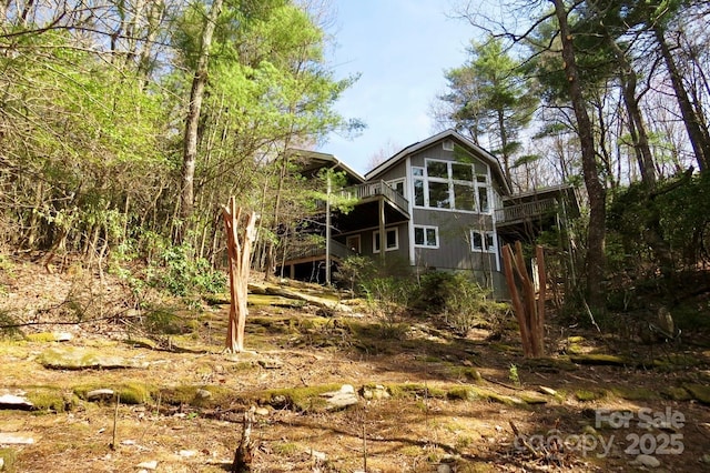 rear view of house with a wooden deck