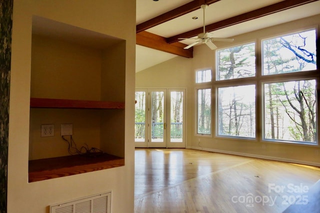 unfurnished living room featuring vaulted ceiling with beams, visible vents, a ceiling fan, and wood finished floors