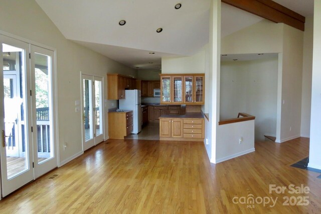 kitchen with glass insert cabinets, white appliances, visible vents, and light wood-style flooring