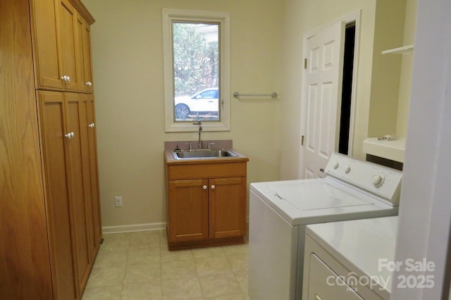 laundry room with light tile patterned floors, independent washer and dryer, a sink, baseboards, and cabinet space