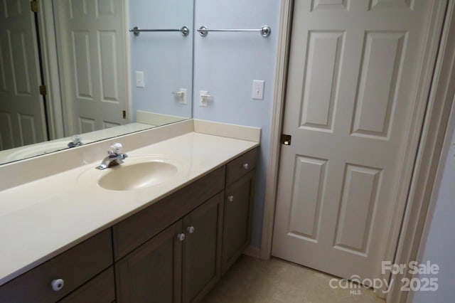 bathroom with tile patterned floors and vanity